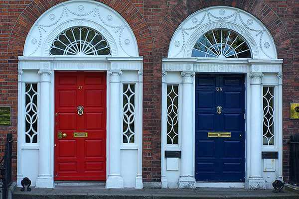 Closeup shot of red and blue front doors adjacent to each other